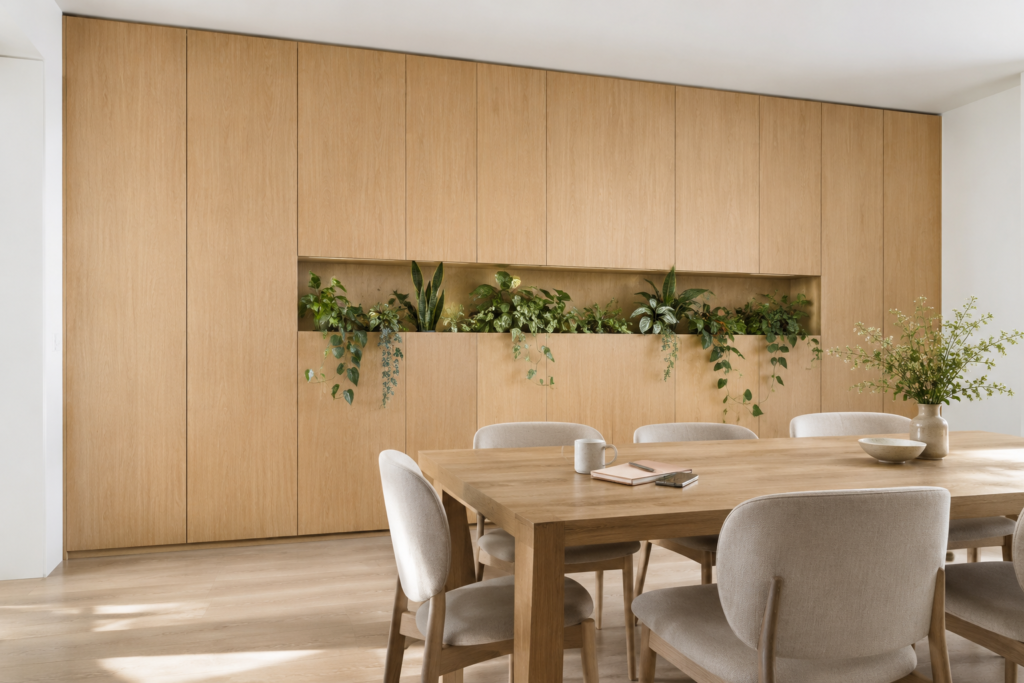 Full-height oak wall cabinetry with a continuous recessed planting band across the center